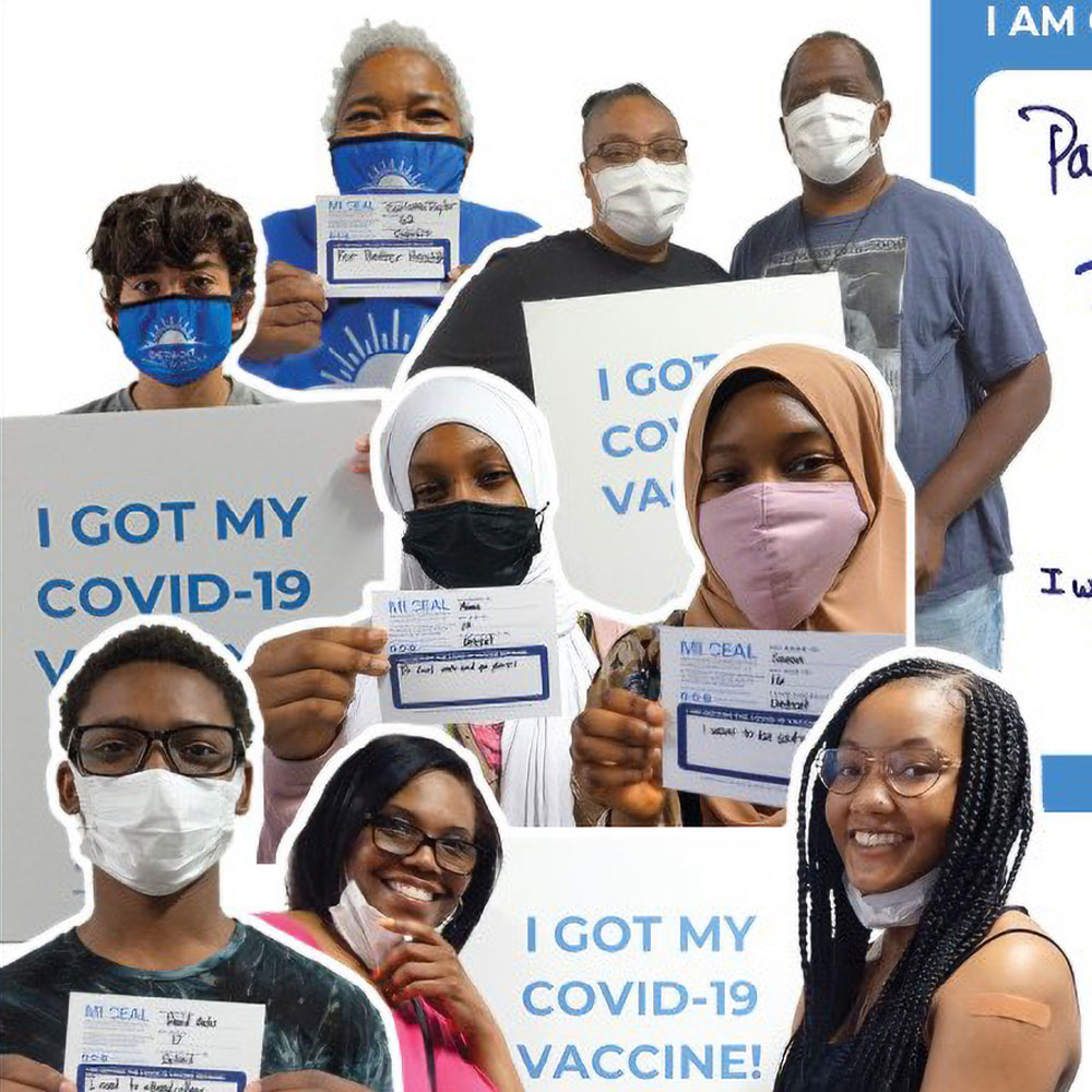 Image of people holding signs saying they were vaccinated