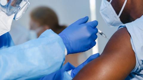 Person receiving vaccine in their arm 
