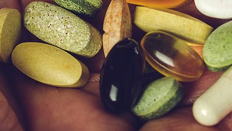 Pouring pills from a bottle into a hand