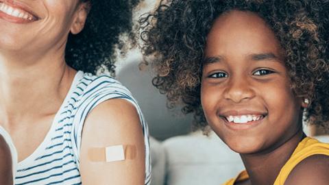 Family with band aids on arms