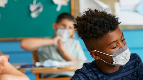 Teacher and children in masks