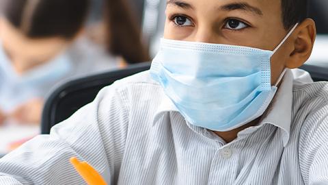 Child in mask at school