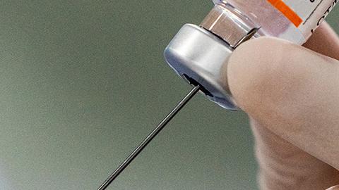 Syringe pulling Covid-19 vaccination 